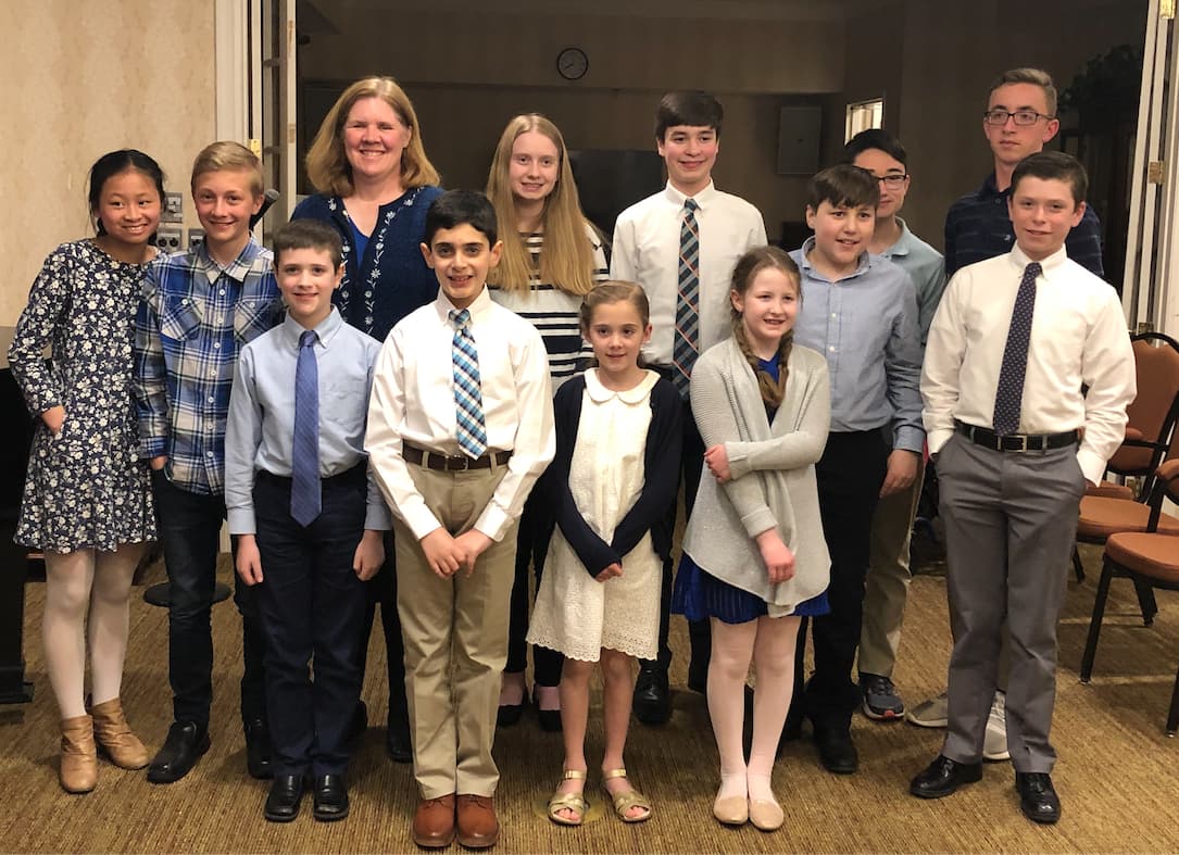 Rene Johnson with school-age piano students